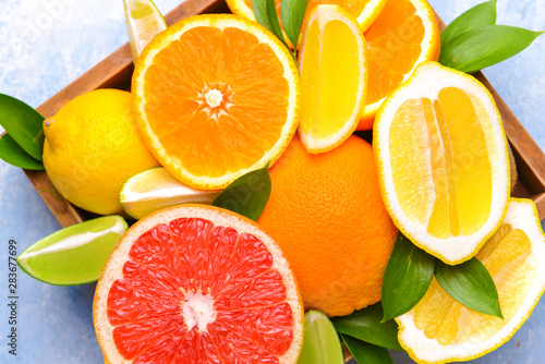 Different citrus fruits in box  closeup