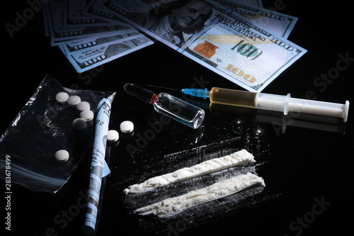 drug trafficking, crime, addiction and sale concept - closeup of with drugs and money.