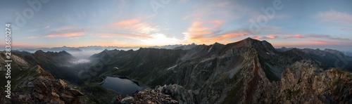 Panoramic mountain landscape at sunrise, Italian Alps. Climbing on a ricky peak
