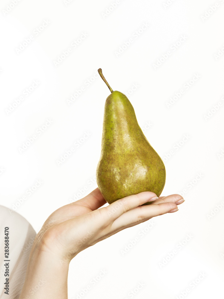 Female hand holding pear fruit. Healthy diet. Female hand holding pear fruit. Healthy diet.