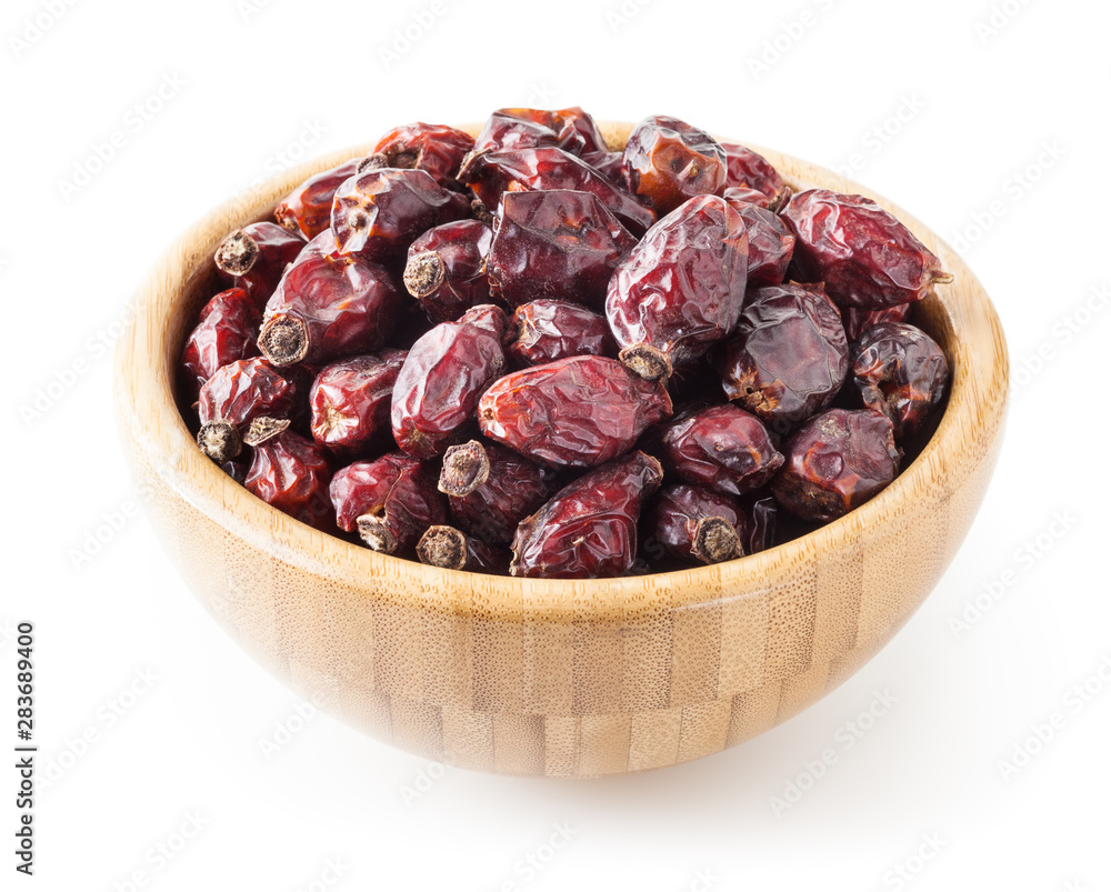 Dried wild rose berries in wooden bowl isolated on white background with clipping path Dried wild rose berries in wooden bowl isolated on white background with clipping path