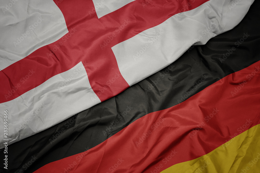 waving colorful flag of germany and national flag of england. waving colorful flag of germany and national flag of england.