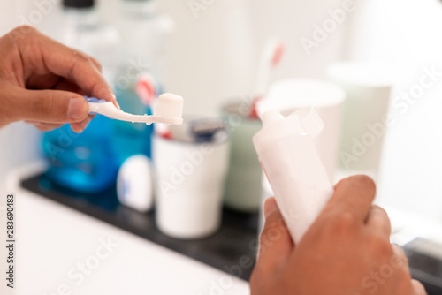 Did you clean your teeth today? Young man is getting ready for a new day. Copy space in lower left part.