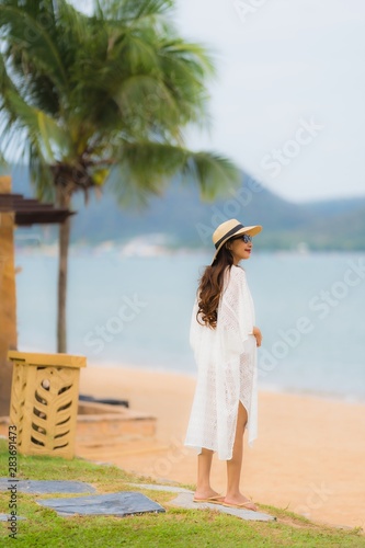 Portrait beautiful young asian woman smile happy relax on the beach sea ocean