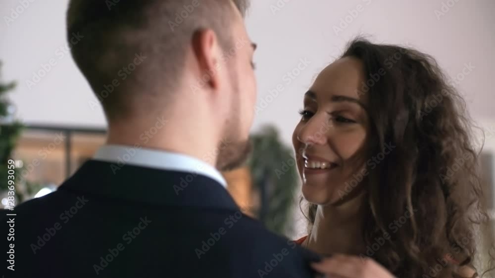 Close-up shot of 20-something Caucasian man and beautiful brunette girlfriend slowly dancing together and looking into each other’s eyes at New Year’s Eve party Close-up shot of 20-something Caucasian man and beautiful brunette girlfriend slowly dancing together and looking into each other’s eyes at New Year’s Eve party
