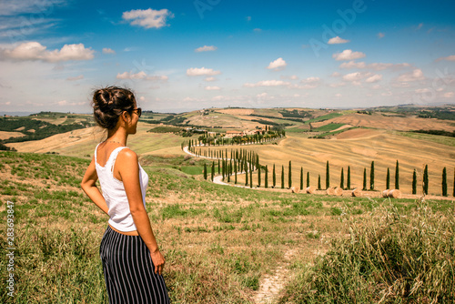 Beautiful landscape scenery of Tuscany in Italy - cypress trees along white road - aerial view -  close to Asciano, Tuscany, Italy photo