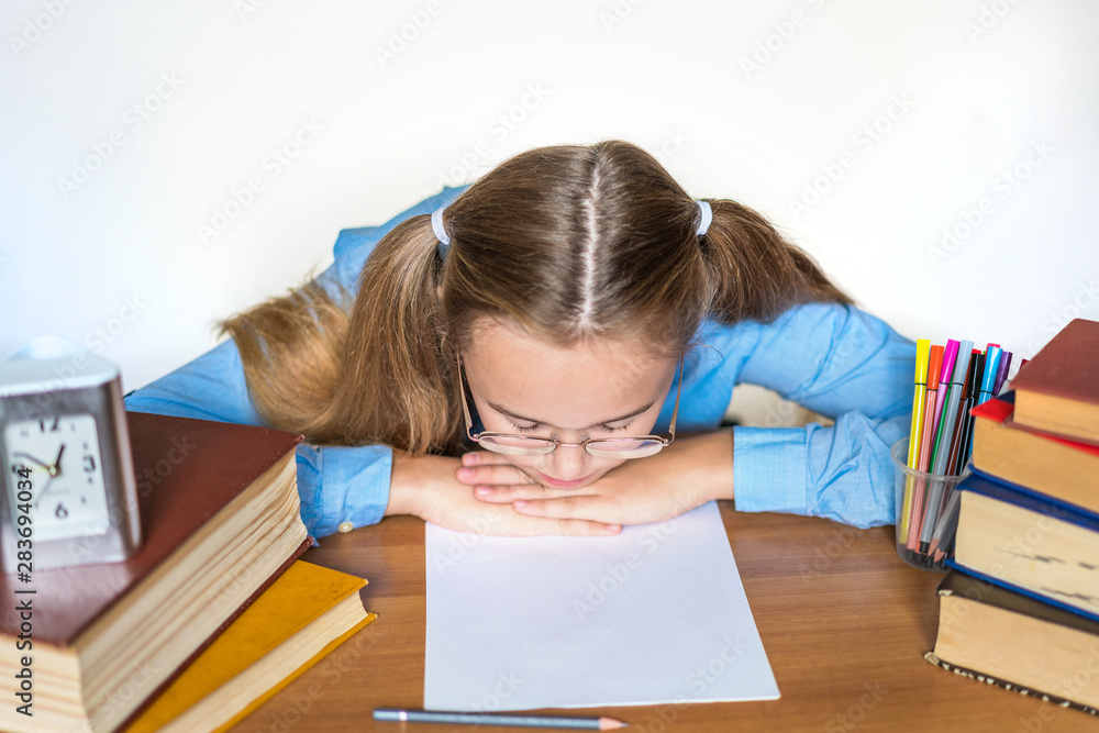 Stressed school girl tired of hard learning with books in exams tests preparation, overwhelmed high school teen girl exhausted with difficult studies or too much homework, cram concept Stressed school girl tired of hard learning with books in exams tests preparation, overwhelmed high school teen girl exhausted with difficult studies or too much homework, cram concept