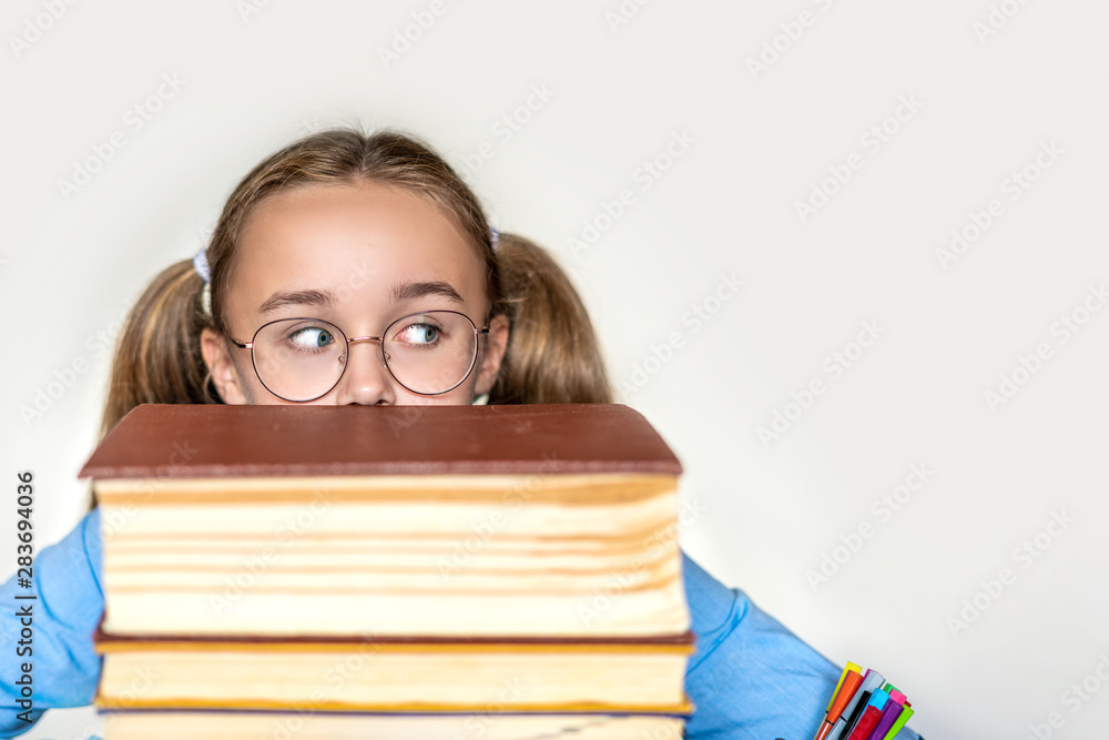 Stressed school girl tired of hard learning with books in exams tests preparation, overwhelmed high school teen girl exhausted with difficult studies or too much homework, cram concept Stressed school girl tired of hard learning with books in exams tests preparation, overwhelmed high school teen girl exhausted with difficult studies or too much homework, cram concept