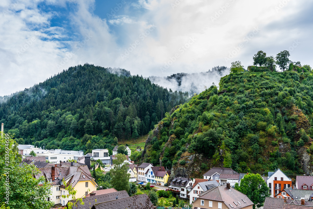 Germany, Little black forest town hornberg, world famous for the story of hornberg shooting in green valley between forested mountains in foggy atmosphere