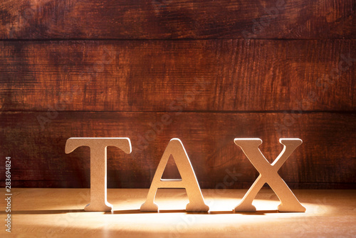 Obraz na płótnie Tax concept on woody background.    税金