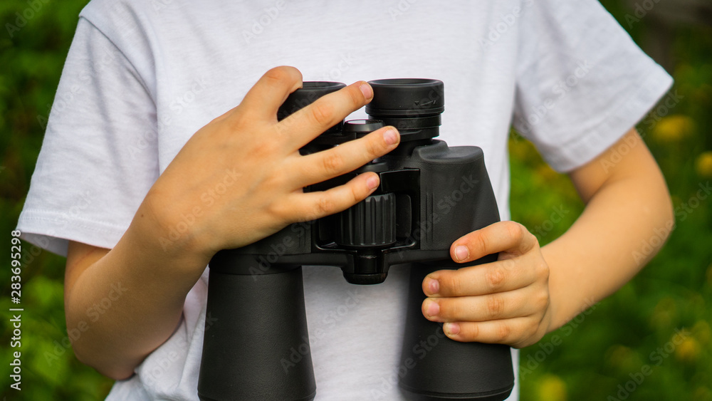 little boy holding binoculars in hands for exploring for Knowledge little boy holding binoculars in hands for exploring for Knowledge
