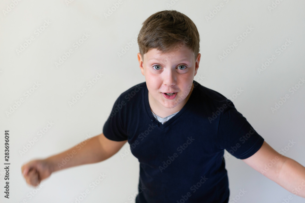 expressive boy on a grey background expressive boy on a grey background