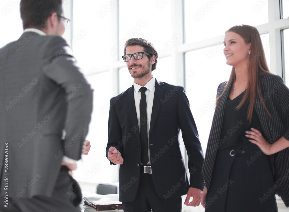 employees discuss something standing in the office employees discuss something standing in the office