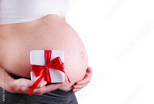 Wallpaper Mural Pregnant woman belly holding gift box isolated on white. Healthy pregnancy background Torontodigital.ca