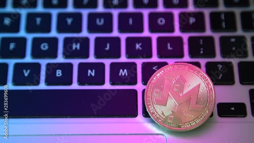 Circle Monerd coin on top of computer keyboard buttons. Digital currency, block chain market, online business photo