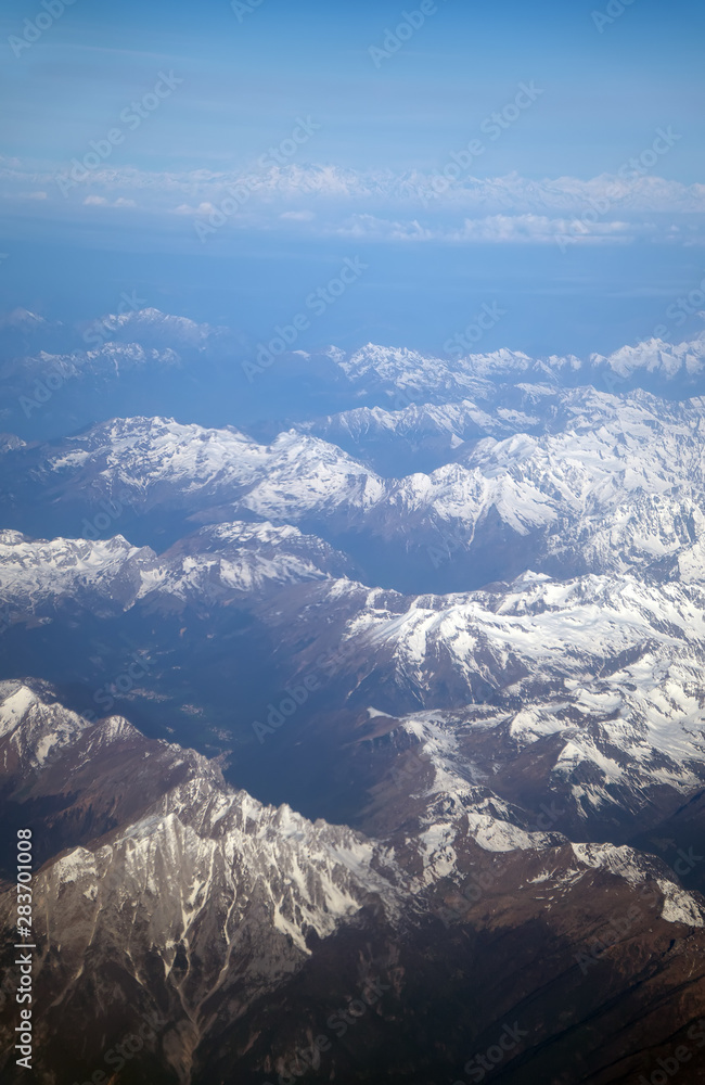Fototapeta premium Aerial view of the mountains in the clouds.