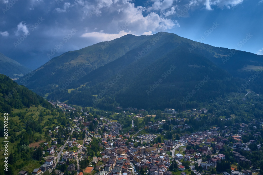 Fototapeta premium Panoramic view of the Ponte di Legno region of Trento the north of Italy. The popular ski resort town of Ponte di Legno. Summer time of the year. Aerial view. Photo taken on a drone.