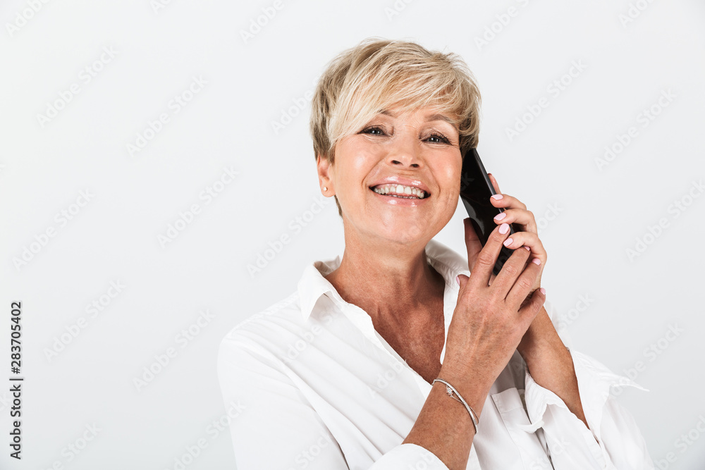 Portrait closeup of happy adult woman with short blond hair smiling and talking on cellphone Portrait closeup of happy adult woman with short blond hair smiling and talking on cellphone