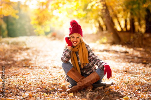 Trendy young woman in fall in park