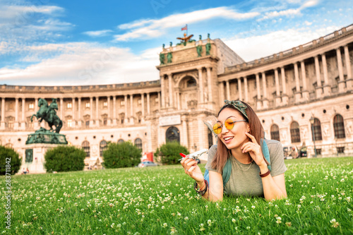 Canvas Print Happy asian girl on a grass lawn playing with toy airplane, as symbol of travelling and transportation for tourists