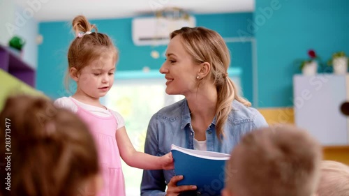 Group of children and teacher in the preschool  