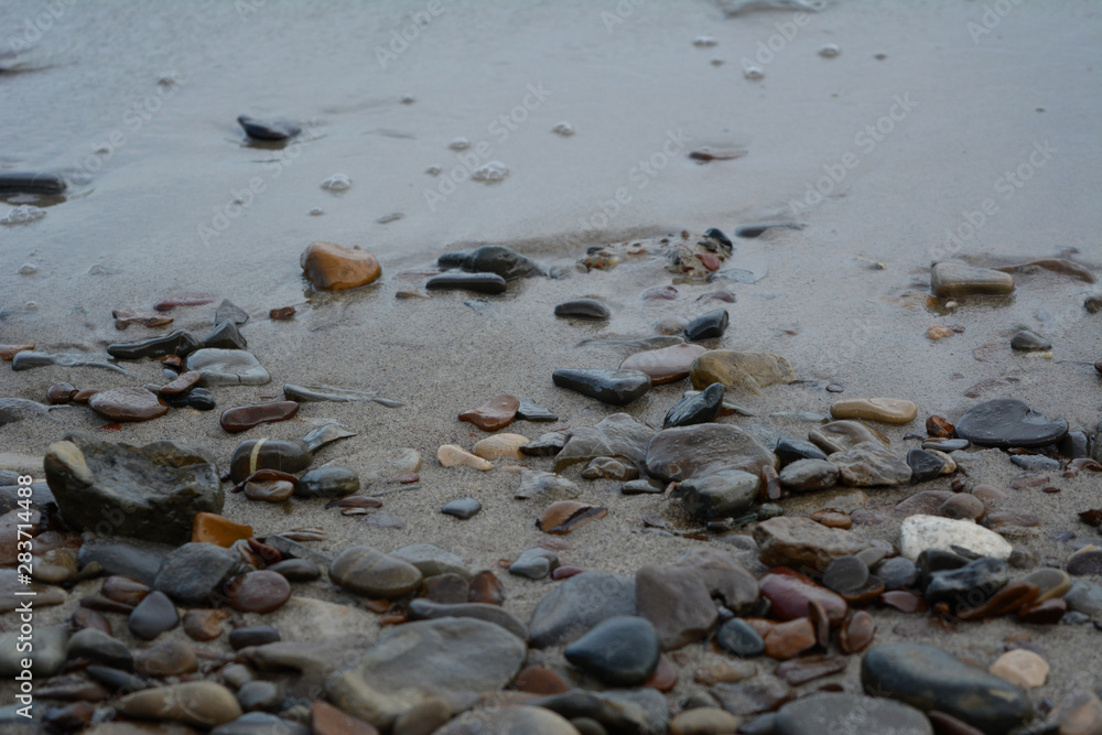 Pebble stones on sandy river bank. Pebble stones on sandy river bank.
