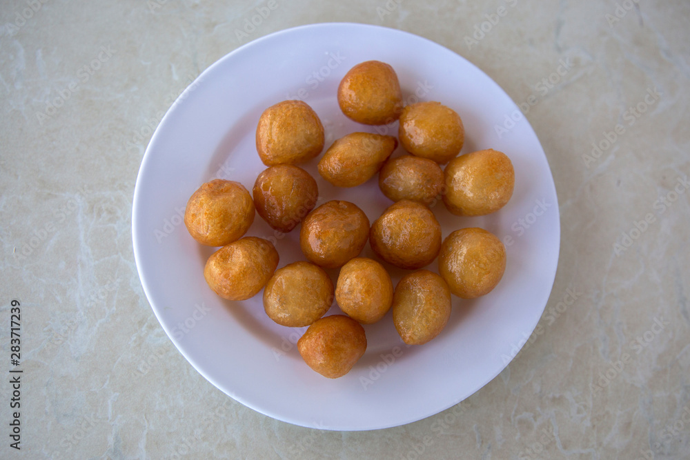 Traditional Turkish Lokma Sweet, fried sweet dough covered in a syrup and served Traditional Turkish Lokma Sweet, fried sweet dough covered in a syrup and served