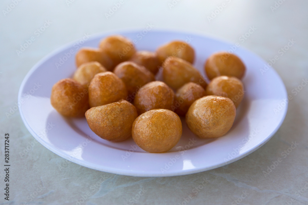 Traditional Turkish Lokma Sweet, fried sweet dough covered in a syrup and served Traditional Turkish Lokma Sweet, fried sweet dough covered in a syrup and served
