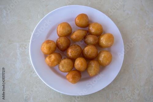 Traditional Turkish Lokma Sweet, fried sweet dough covered in a syrup and served