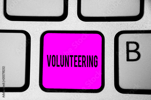 Conceptual hand writing showing Volunteering. Business photo text Provide services for no financial gain Willingly Oblige Keyboard purple key Intention create computer reflection document photo