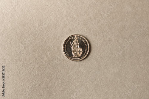 Silver coin on grey background. Close up.