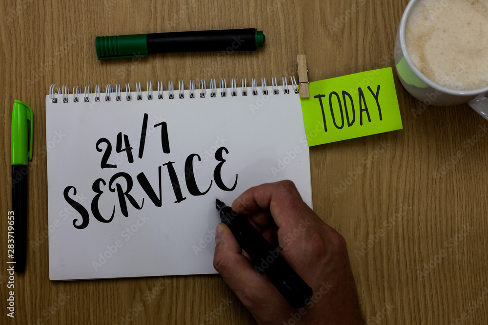 Writing note showing 24 7 Service. Business photo showcasing Always available to serve Runs constantly without disruption Man holding marker notebook clothepin reminder wooden table cup coffee Writing note showing 24 7 Service. Business photo showcasing Always available to serve Runs constantly without disruption Man holding marker notebook clothepin reminder wooden table cup coffee