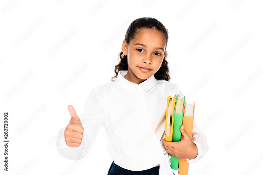 adorable african american schoolgirl showing thumb up while looking at camera isolated on white adorable african american schoolgirl showing thumb up while looking at camera isolated on white