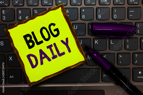 Handwriting text Blog Daily. Concept meaning Daily posting of any event via internet or media tools Yellow paper keyboard Inspiration communicate ideas messages black markers photo