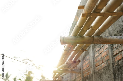 Strong bamboo foothold supporting builder to build under construction house