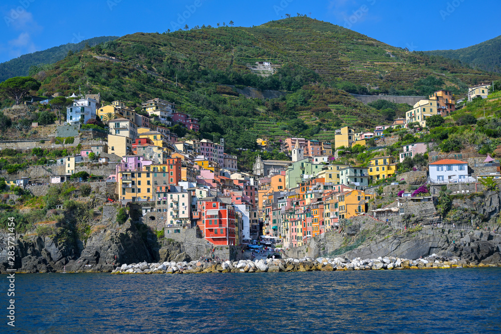 Colorful houses of Riomaggiore, a Cinque Terra mountain village and tourist destination on the steep coast of the Mediterranean sea in Liguria, Italy