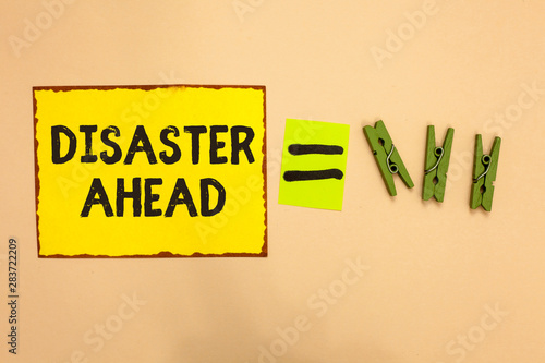 Word writing text Disaster Ahead. Business concept for Contingency Planning Forecasting a disaster or incident Yellow piece paper reminder equal sign several clothespins sending message