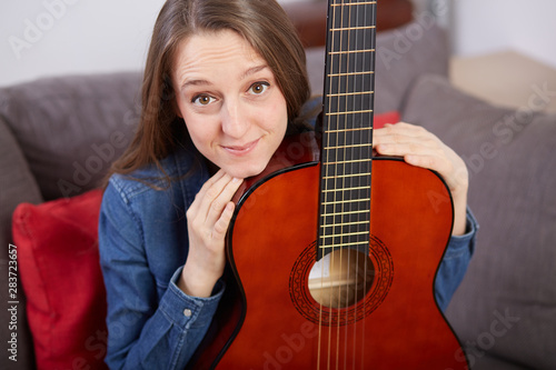 woman play guitar at home