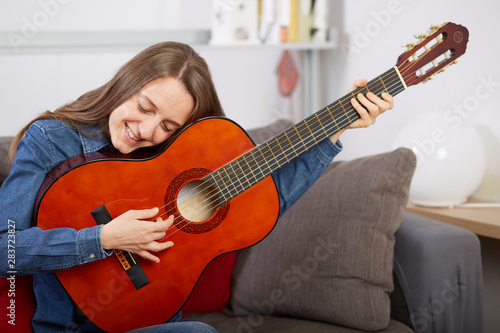 woman play guitar at home