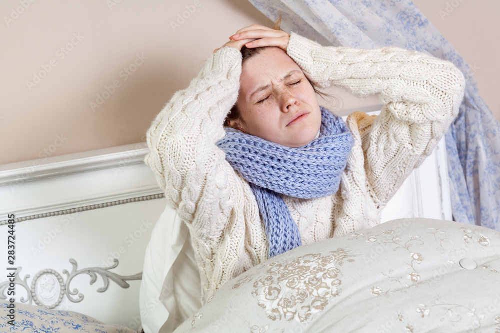 Sad alone young woman in white sweater 