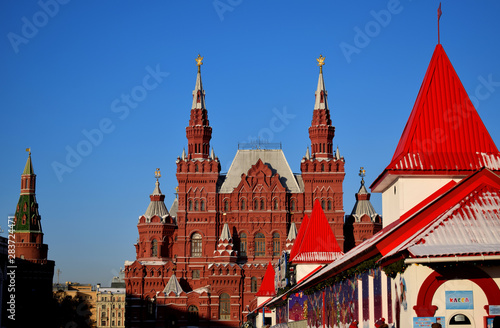Moscow, Russia - December 16, 2018: The State Historical Museum and GUM ice skating rink in Red Square against the blue sky 
