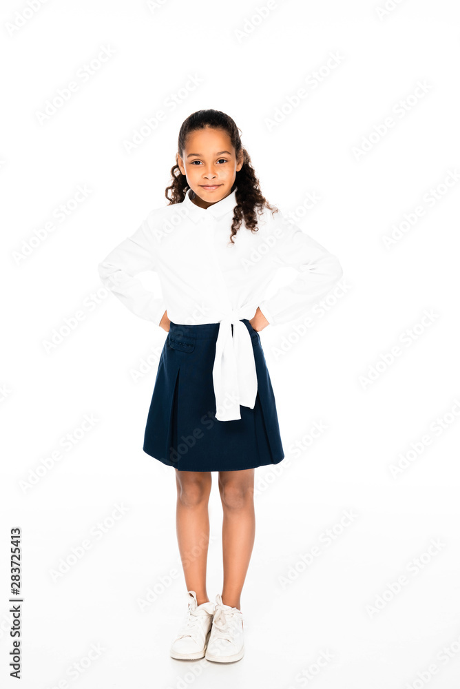 full length view of smiling african american girl posing at camera on white background full length view of smiling african american girl posing at camera on white background