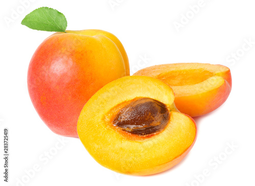 apricot fruits with slices and green leaf isolated on white background