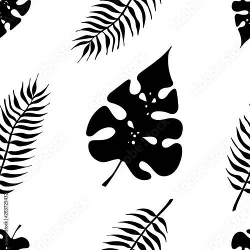 tropical seamless of leaves silhouettes Monstera and palm photo