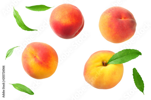 peach fruit with green leaves isolated on white background. top view