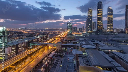 Wallpaper Mural Aerial view of Financial center road night to day transition timelapse with shopping mall and under construction building with cranes from downtown, Dubai Creek harbor on background Torontodigital.ca