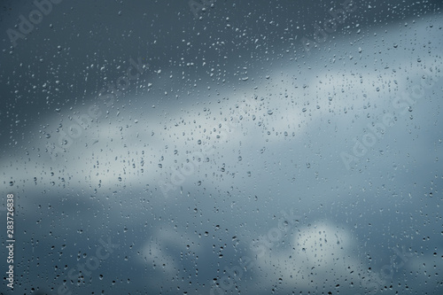 Raindrops on a window during bad, rainy weather.