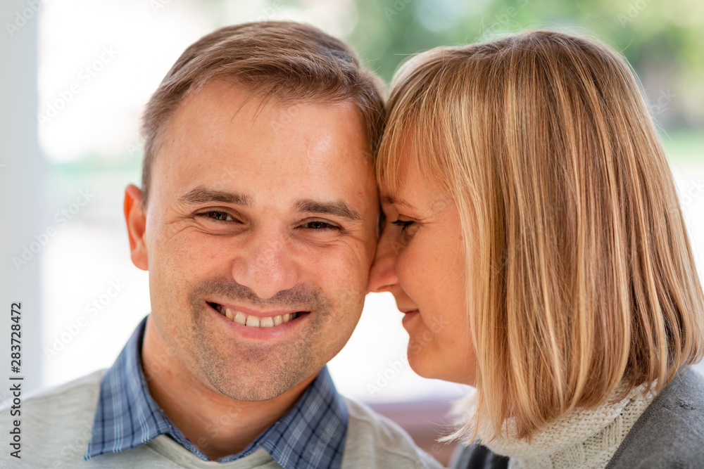 Happy young couple hugging and laughing together in the park Happy young couple hugging and laughing together in the park