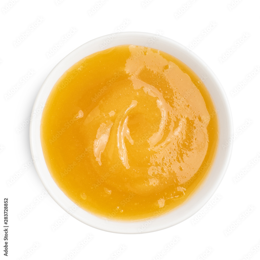 Thick honey in dark bowl on white background. Top view Thick honey in dark bowl on white background. Top view