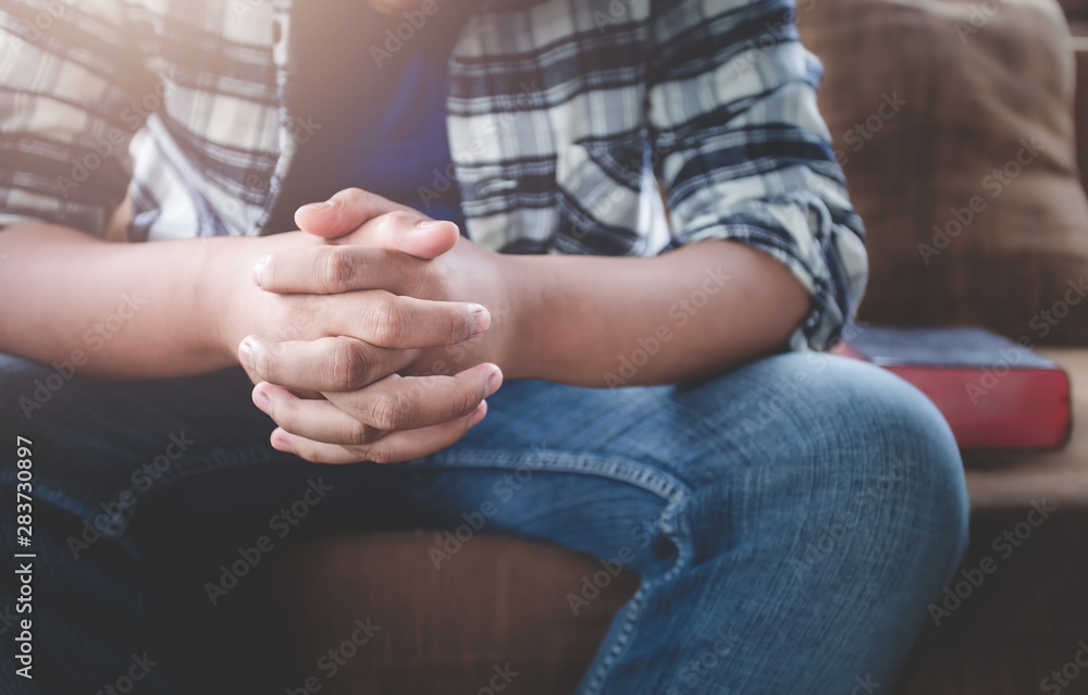 Close up hands of young male praying by believe in God. Christian prayer concept.